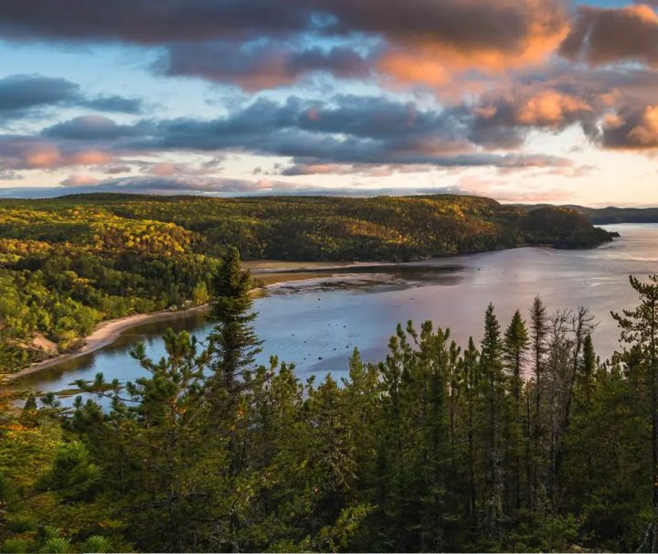 This image shows a scenic cycling tour on a quiet paved road in the Saguenay region of Quebec