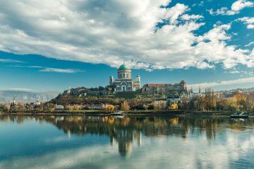 A cathedral perched on a small island with magnificent views surrounding of water and mountains on a warm sunny day on a bike tour or walking tour in Europe with Freewheeling Adventures.