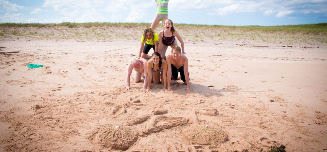 Human Pyramid on the beach on tour with Freewheeling Adventures