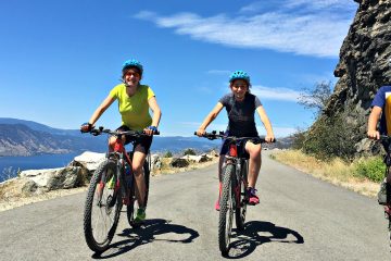 3 happy cyclists on a traffic free cycling path with on our Okanagan & Kettle Valley Railway Bike