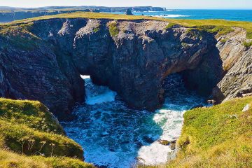 2 natural arches formed by collapse of a former sea cave. Dungeon Provincial Park, Bonavista Peninsula, Eastern Newfoundland, Canada.