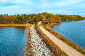 A view of 2 people walking in western Cape Breton Island following a traffic-free trail - flat and very easy with Freewheeling Adventures.