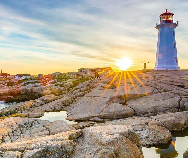 A sunset view of the lighthouse of the famous Peggy's Cove in Nova Scotia on our South Shore Hike