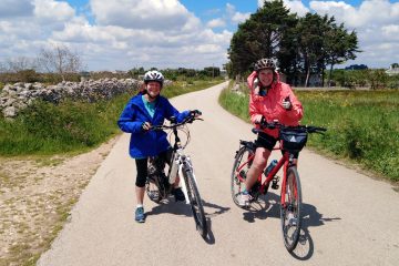 Happy cyclists posing on a traffic free biking path on a Freewheeling Adventure tour in Puglia Italy.