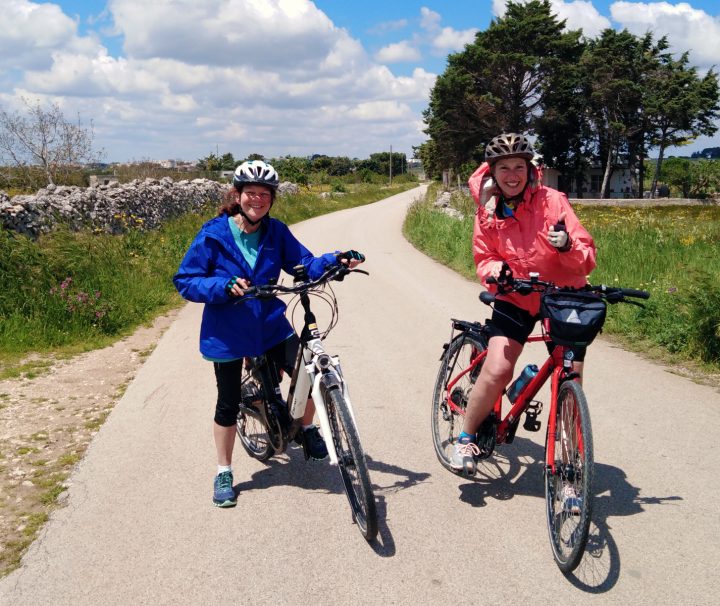 Happy cyclists posing on a traffic free biking path on a Freewheeling Adventure Italy Bike Tours