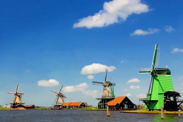 A classic Netherlands windmill on a beautiful day on the easy Amsterdam to Antwerp Bike Tour or Amsterdam to Arnhem Walking Tour with Freewheeling Adventures.