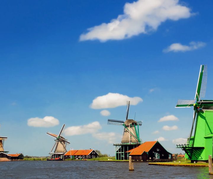 A classic Netherlands windmill on a beautiful day on the easy Amsterdam to Antwerp Bike Tour or Amsterdam to Arnhem Walking Tour with Freewheeling Adventures.