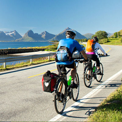 This image shows a scenic cycling tour through the Lofoten Islands in Norway