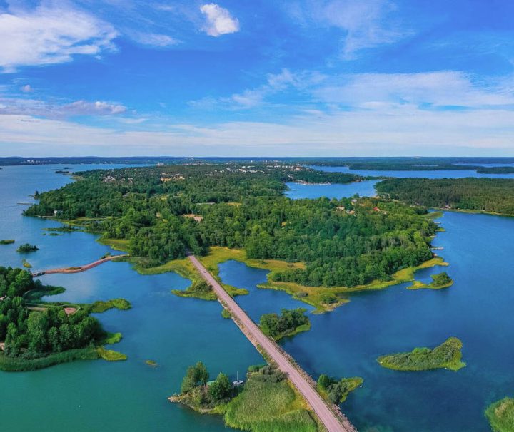 This aerial view captures a scenic road connecting islands in the Åland Archipelago in Finland