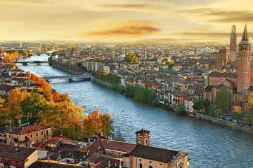 This image shows a scenic view of the city of Verona, Italy, along the Adige River