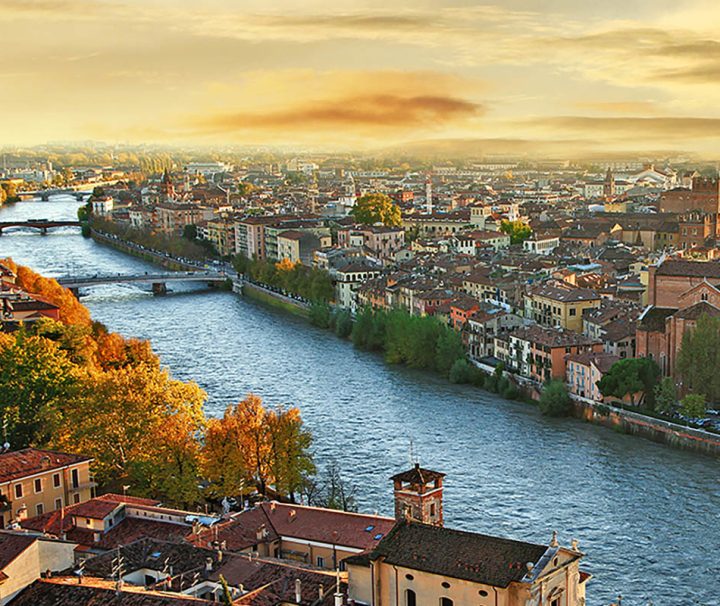 This image shows a scenic view of the city of Verona, Italy, along the Adige River