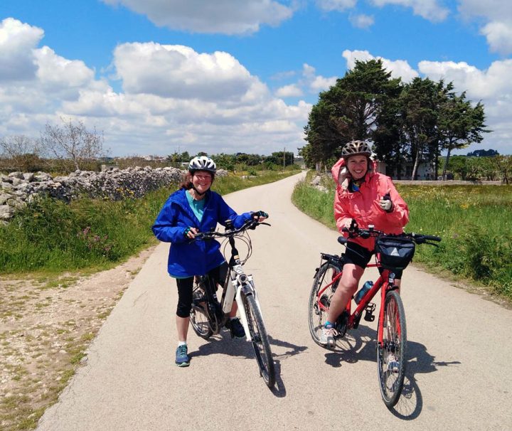 This image shows a moment from a guided bicycle tour in southern Italy, specifically touring through the Puglia and Basilicata regions