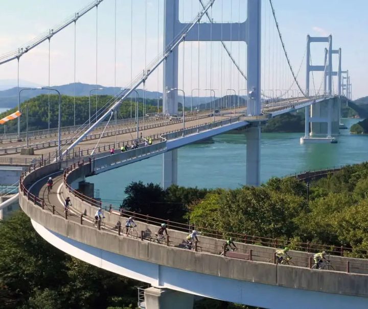 This image depicts a moment on the Shimanami Kaidō, a famous cycling route in Japan that spans the Seto Inland Sea