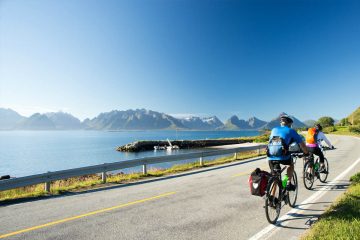 This image shows a scenic cycling tour through the Lofoten Islands in Norway