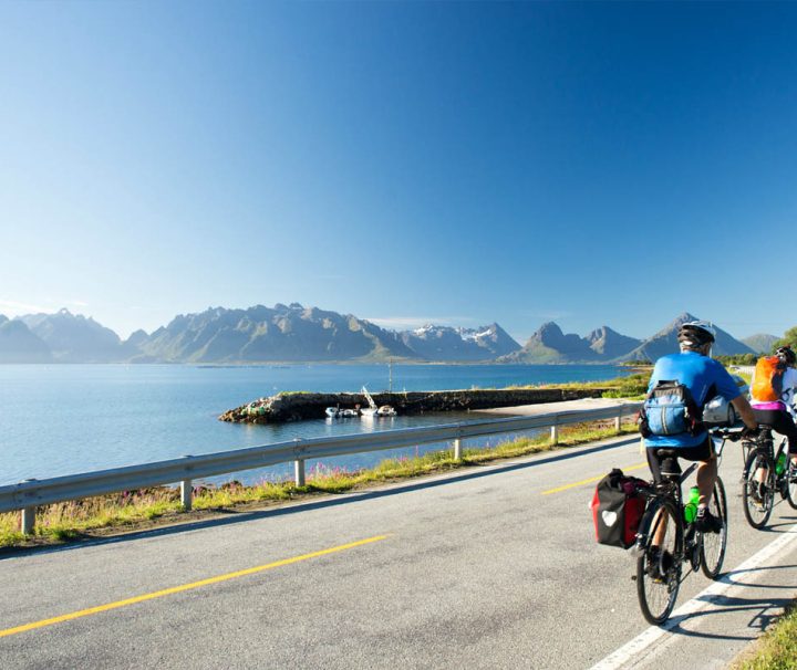 This image shows a scenic cycling tour through the Lofoten Islands in Norway